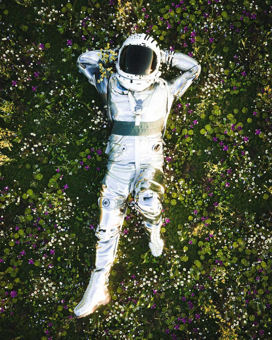 Astronaut lying in a field